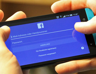 Zwei Hände halten ein Android-Smartphone, auf dem die Anmeldemaske der Facebook-App zu sehen ist. Bild: checked4you